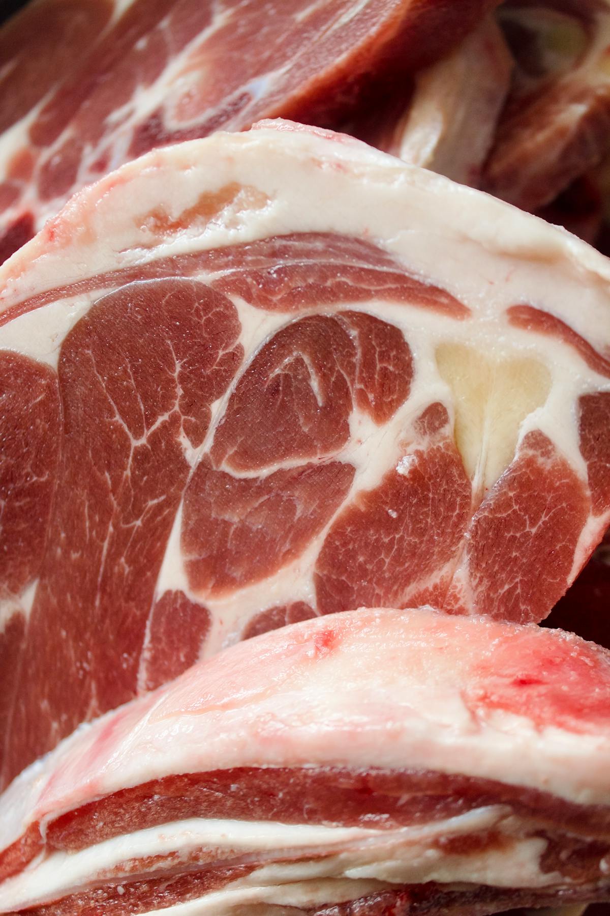 Frozen packaged meat stacked in a home freezer, the kind of refrozen inventory the USDA rules apply to