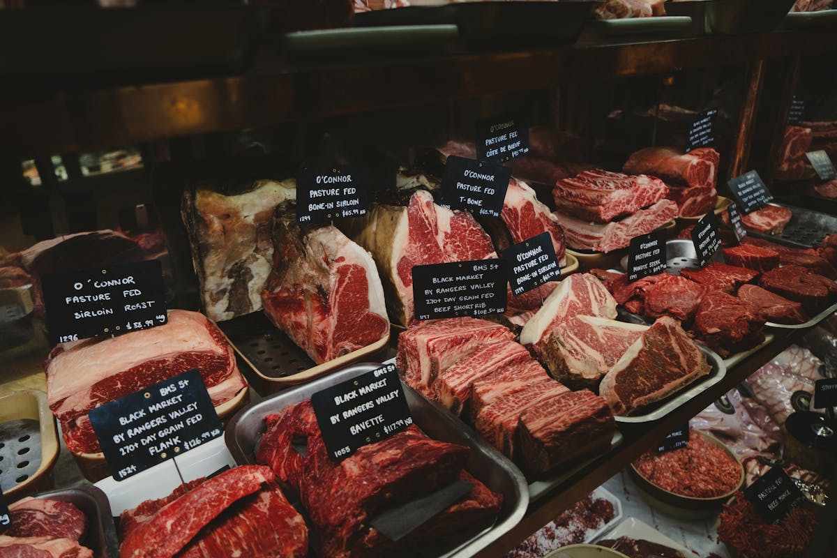 Raw meat sitting out on a counter surface, illustrating the unsafe room-temperature thawing the USDA warns against
