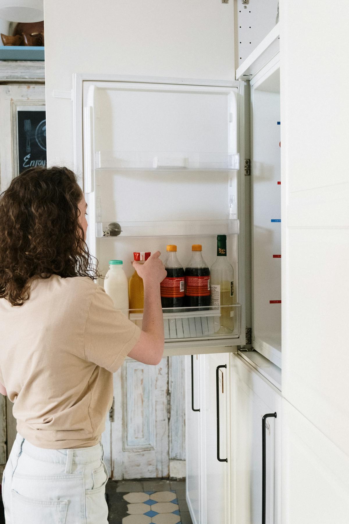 Refrigerator food prep scene with fresh ingredients laid out, illustrating cold fridge thawing as the safest defrost method