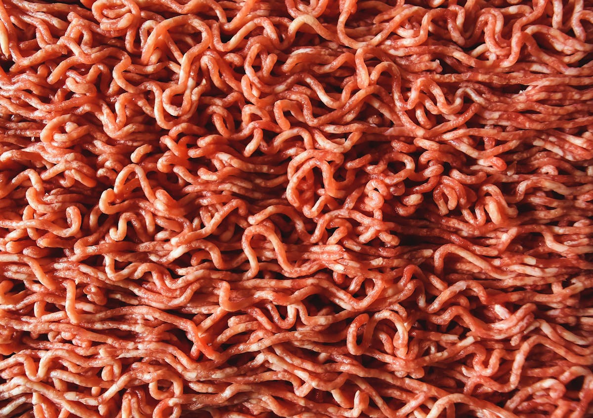 Fresh raw ground beef portioned for cooking, ready to be sealed and submerged for the 30-minute cold water thaw method